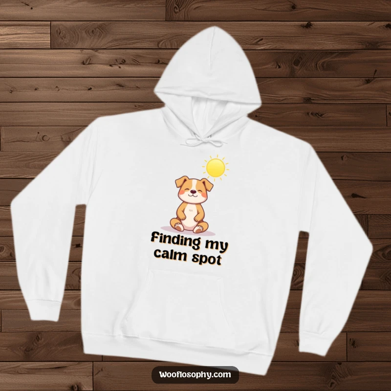 Funny hoodie: a dog sits in a serene meditation pose under a bright, beaming sun, radiating inner peace.