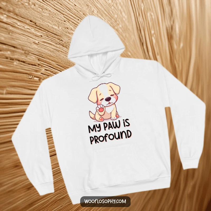 Funny hoodie depicting a dog having a humorous, profound realization while looking at its own paw, ideal for relaxation.
